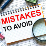 Text Mistakes To Avoid on notepad with calculator, clips, pen on financial report